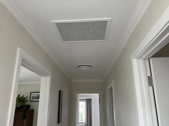 Hallway ceiling return-air grille in a painted home interior in Morphett Vale
